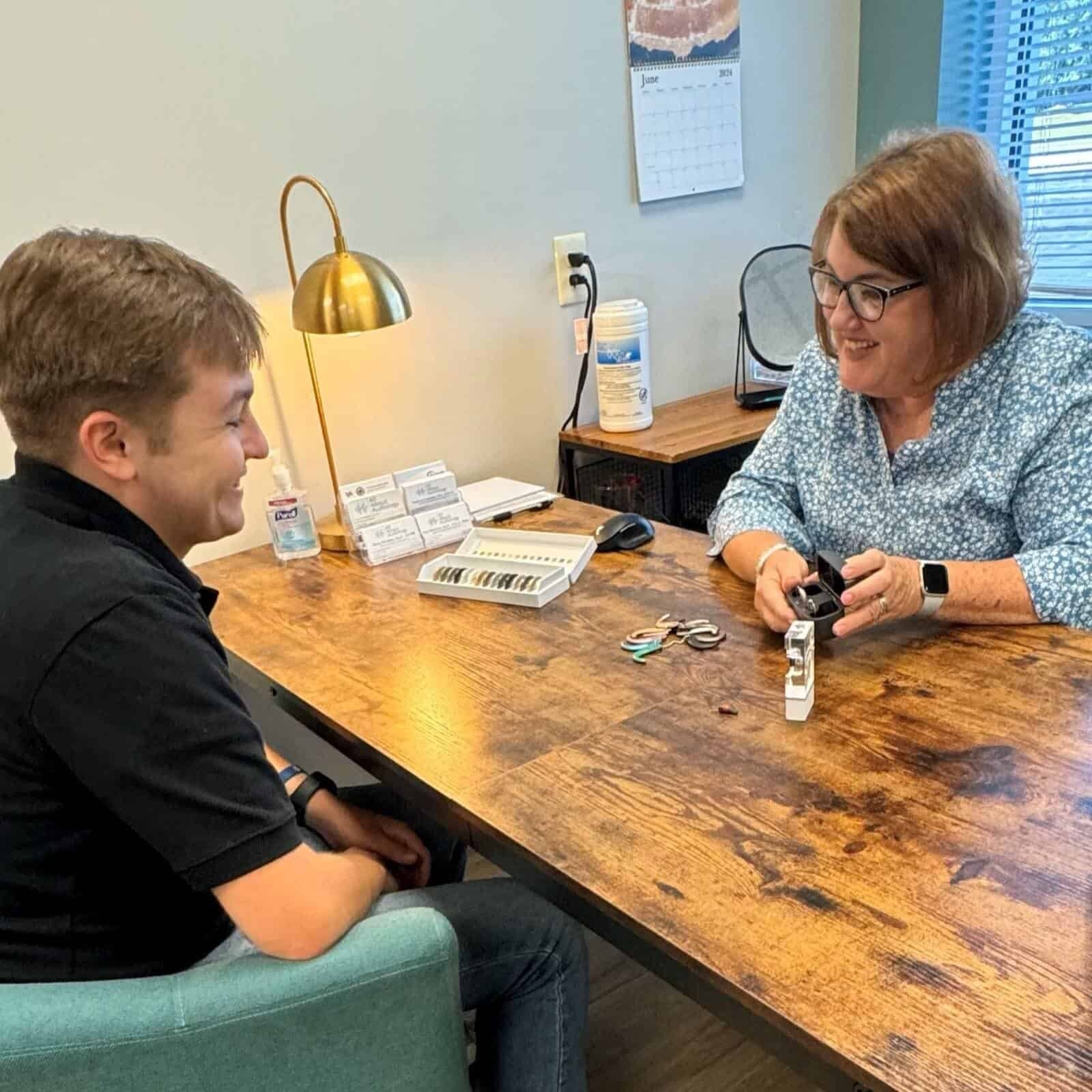 A hearing aid check at the consultation table