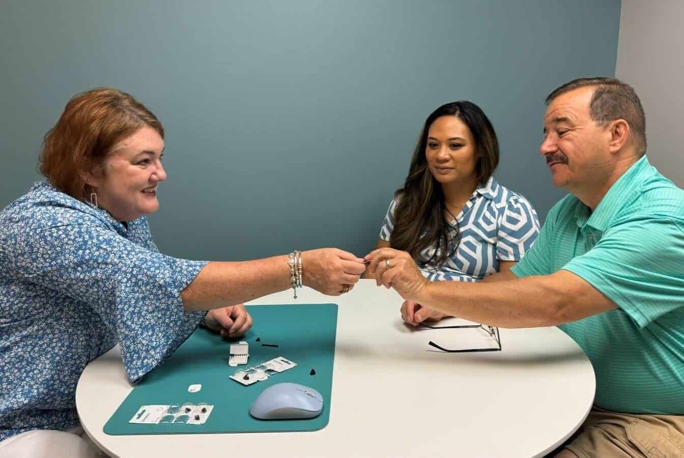 Handing over new hearing aids at the round table